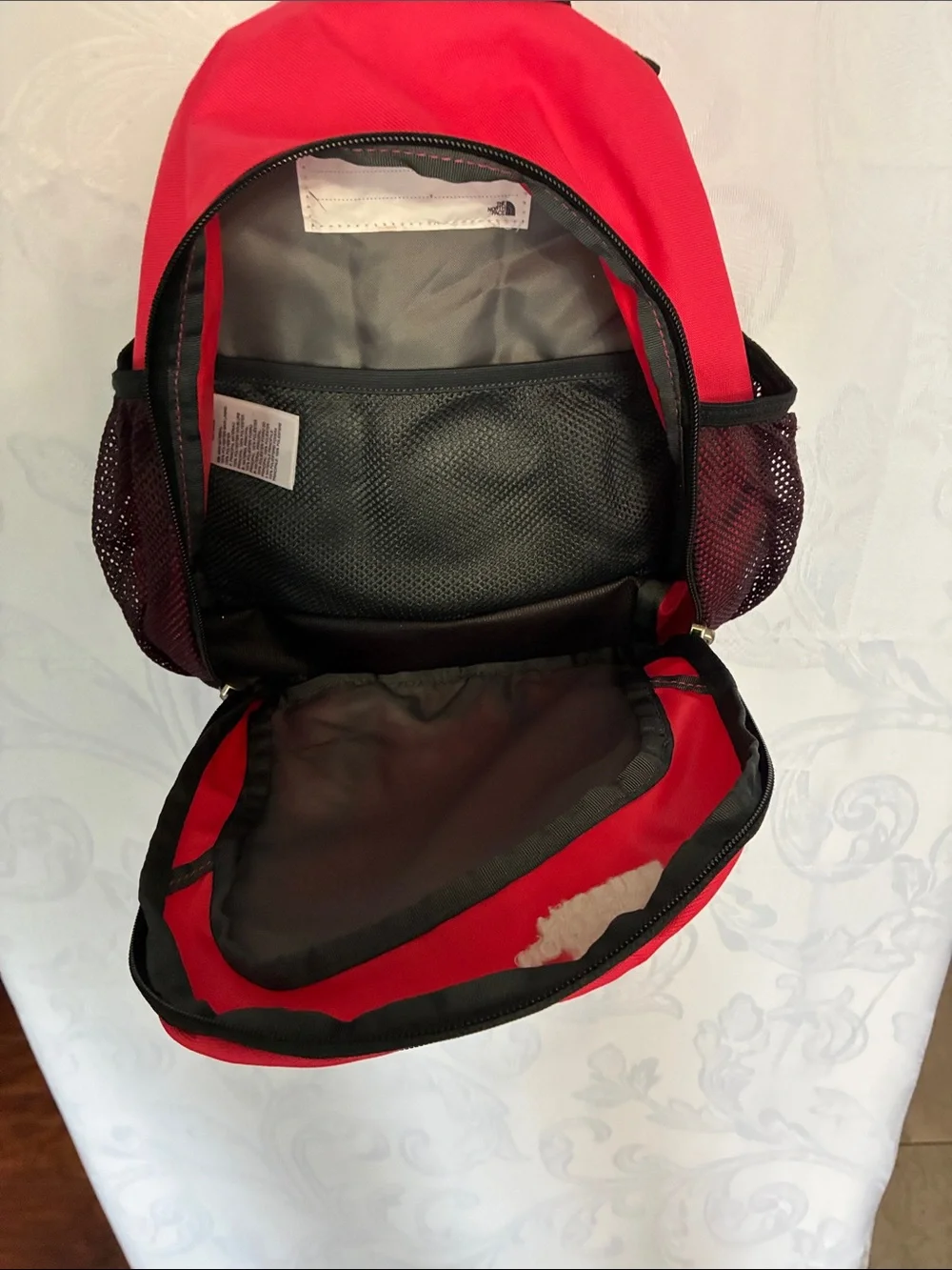 The North Face red and black Sprout backpack